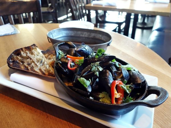Thai-style mussels with Upslope White Thai IPA, kaffir lime and lemongrass infused coconut milk, Thai basil, cilantro, Fresno chilies, shallots, and French country bread at Euclid Hall