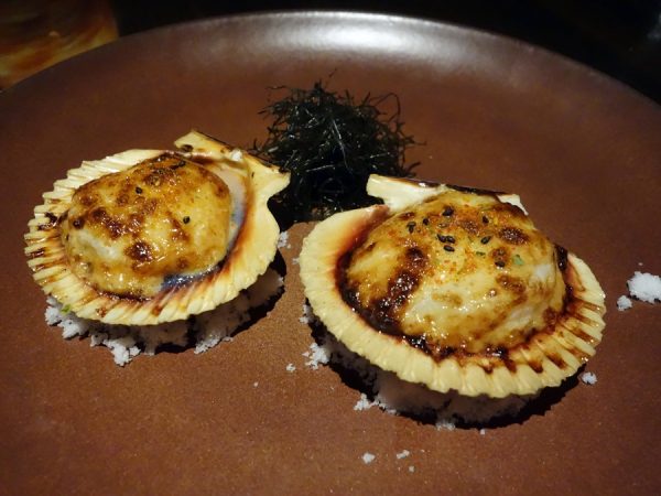Baked scallops on the half shell with tobiko mayo, shichimi sea salt, and ogo seaweed at Japengo